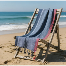 Handloomed turkish cotton bath towel with indigo tribeca handmade blue white and red stripes draped over wooden chair