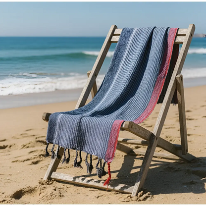 Handloomed turkish cotton bath towel with indigo tribeca handmade blue white and red stripes draped over wooden chair