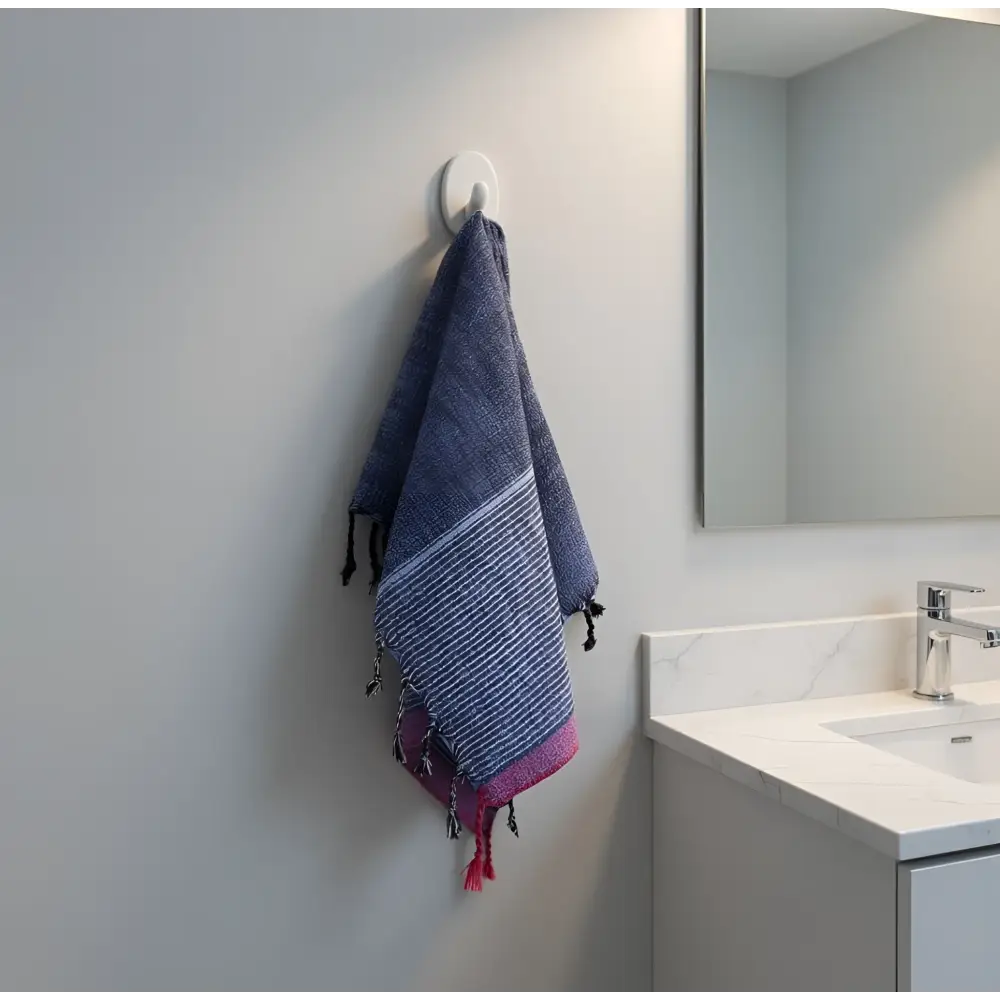 A handloomed turkish cotton bath towel in navy blue and pink stripes with fringed edges by skilled artisans indigo tribeca