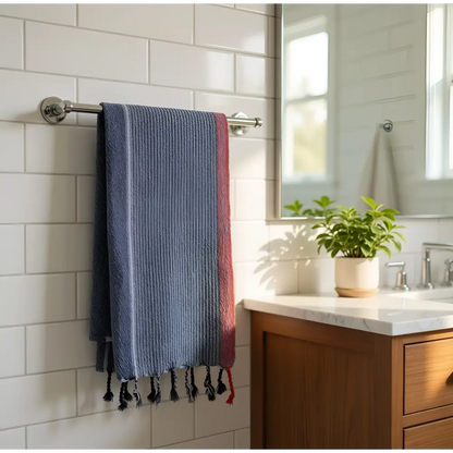 A handmade handloomed turkish cotton bath towel with indigo tribeca stripes and black tassels by skilled artisans