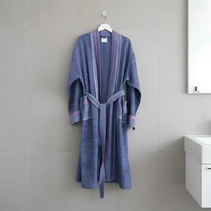 A soft blue and purple striped cotton robe with matching belt hanging on a white hanger by skilled artisans indigo tribeca handmade beautiful design