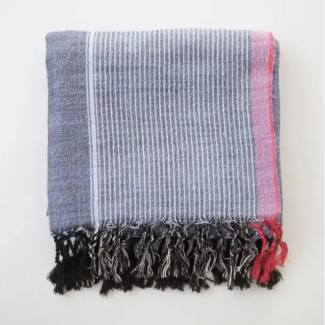 Striped handloomed Turkish cotton throw blanket in indigo blue, white, red stripes with pink fringe border