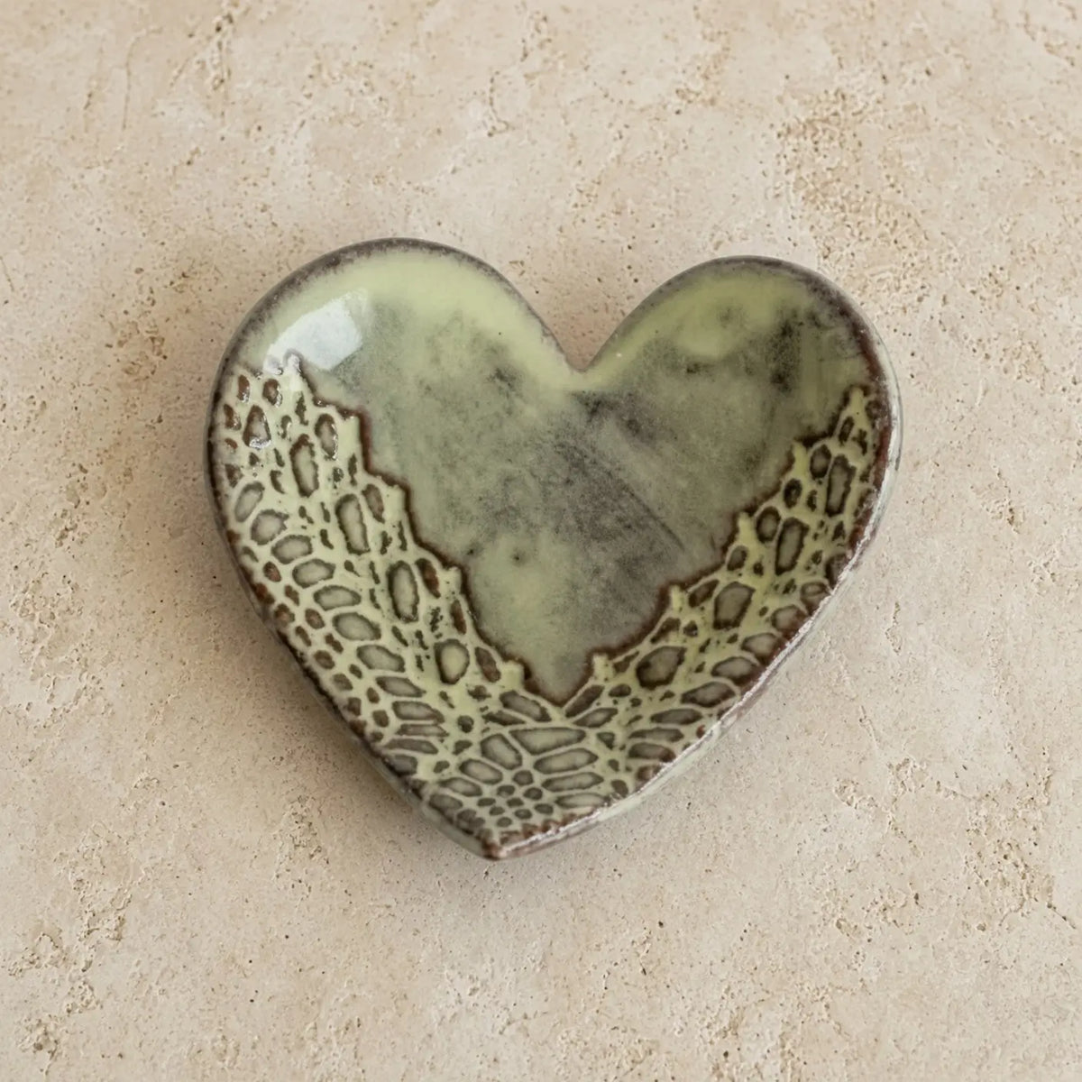 Handmade ceramic heart trinket dish with sage green glaze and brown lace patterns perfect as a heart trinket ring holder