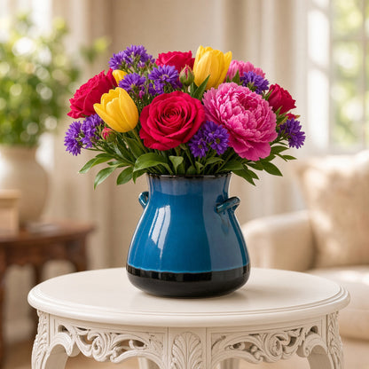 Vibrant bouquet in handmade ceramic vase with blue reactive glaze and white gradient from bat trang village