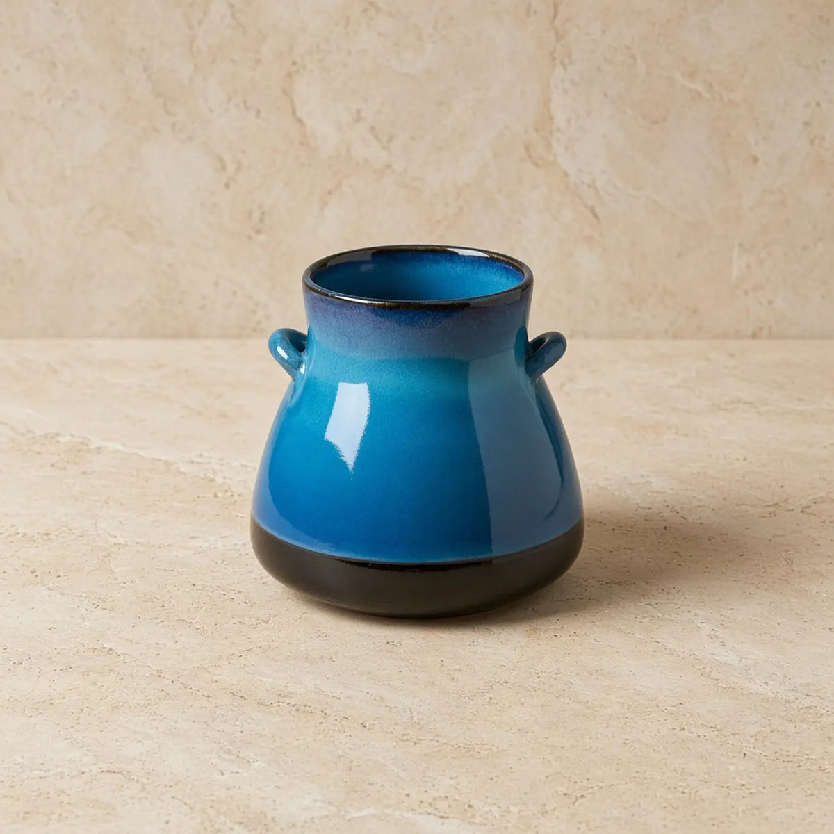 Handmade ceramic vase from bat trang village with vibrant blue reactive glaze and black base with two small handles