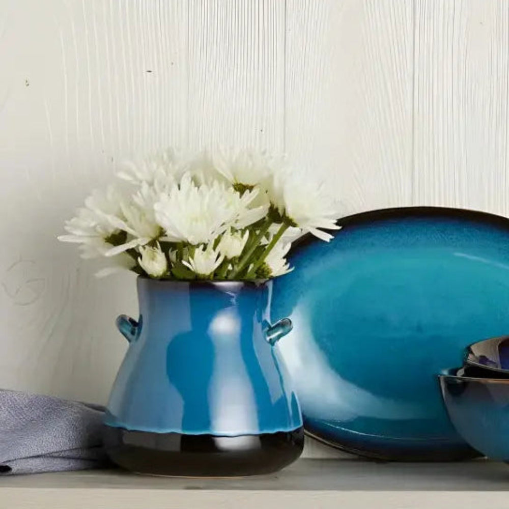 Handmade blue ceramic dinnerware set with earthy brown accents and glossy glaze