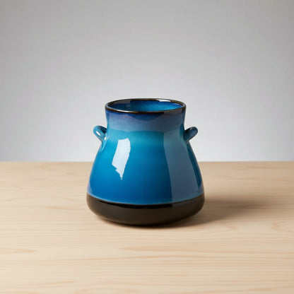 Handmade ceramic vase with blue and white gradient and black handles from Bat Trang