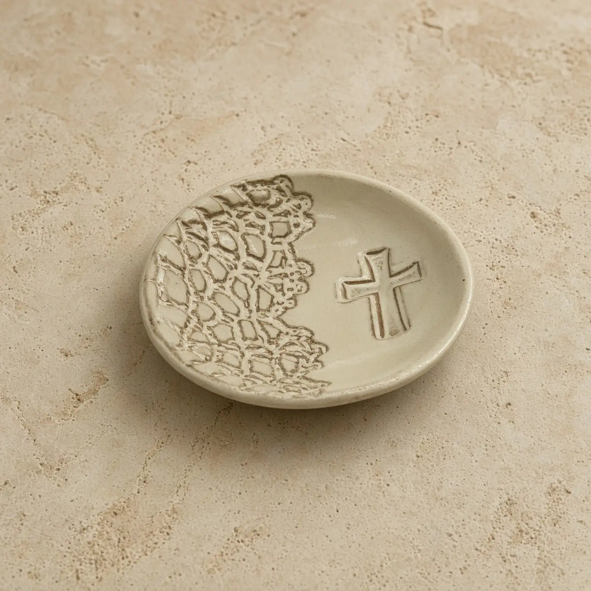 Cream-colored handmade cross ring dish with lace-like pattern and embossed cross perfect unique gift for trinkets