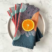 Colorful handmade eco-friendly blue linen dinner napkins set with bright orange slice