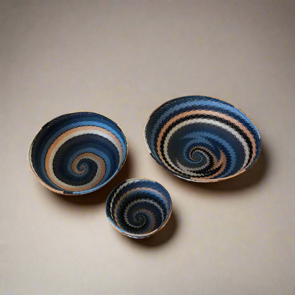Three handmade South Africa city lights woven baskets with blue, brown, and off-white spiral patterns