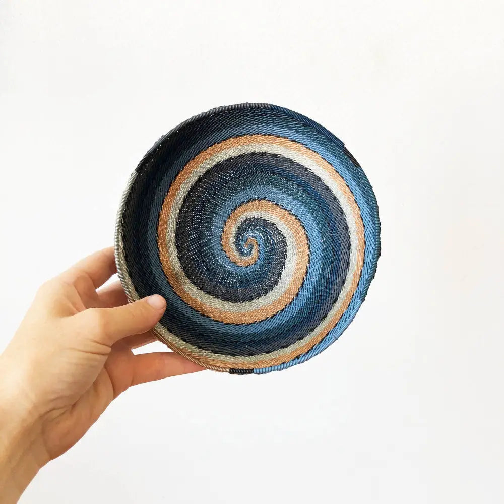 Hand-woven city lights basket from South Africa with blue, white, and peach shades