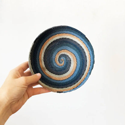 Hand-woven city lights basket from South Africa with blue, white, and peach shades