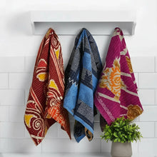White floating shelf with colorful handmade eco-friendly Kantha towels hanging