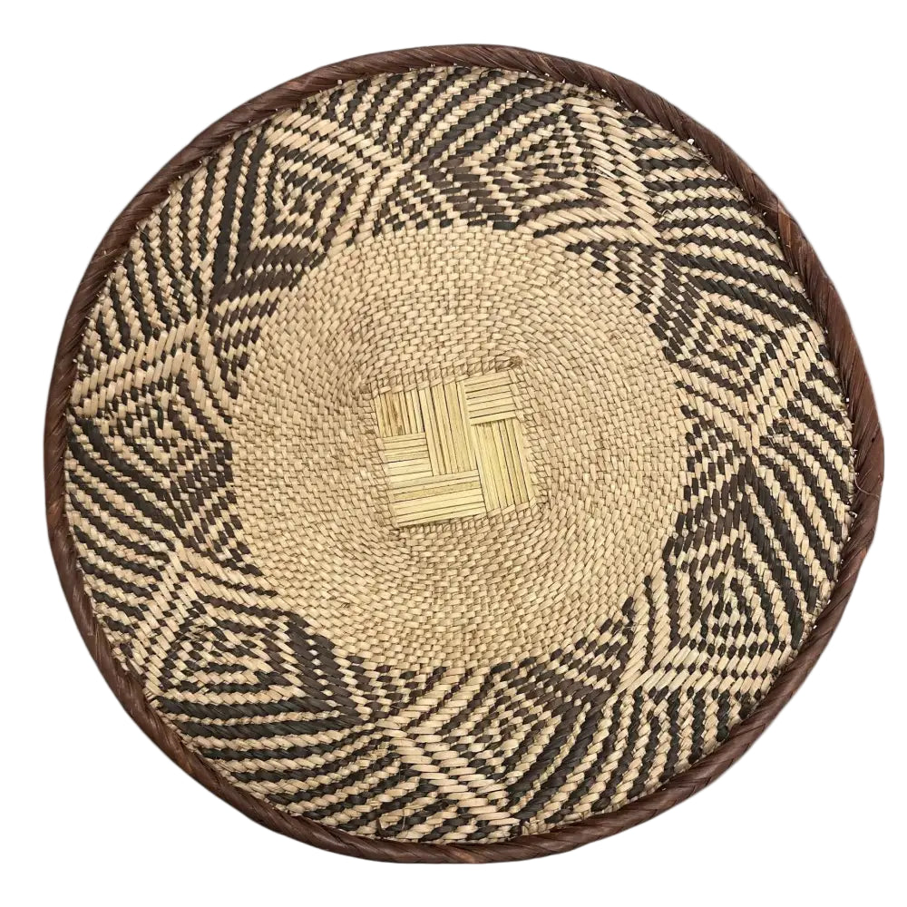 Handmade eco-friendly palm leaves basket from Zimbabwe with geometric patterns and natural fibers