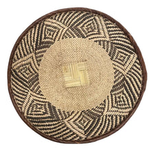 Handmade eco-friendly palm leaves basket from Zimbabwe with geometric patterns and natural fibers