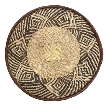 Handmade eco-friendly palm leaves basket from Zimbabwe with geometric patterns and natural fibers