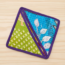 Handmade eco-friendly pot holder with colorful floral and leaf patterns in green, blue, and purple