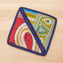 Handmade eco-friendly pot holder with colorful geometric patterns and purple trim