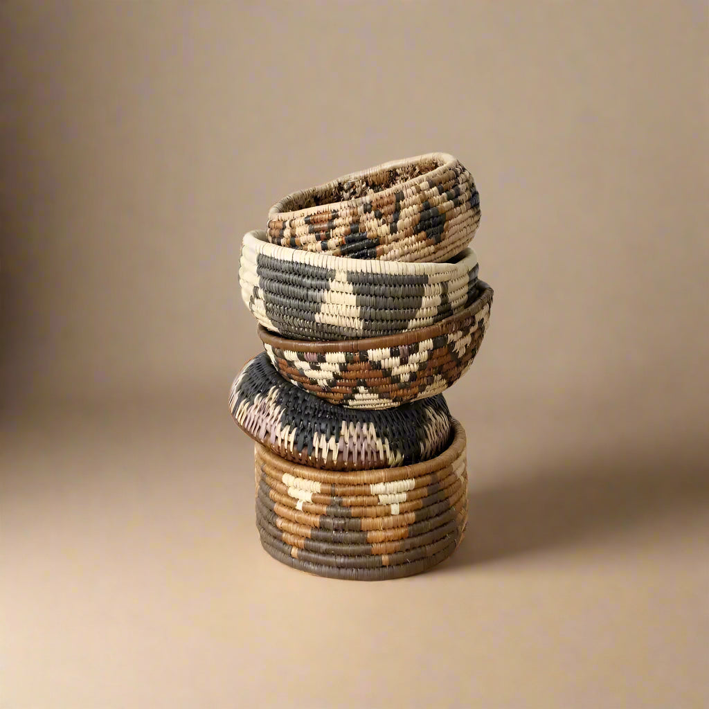 Stack of five South African woven baskets with geometric patterns in the woven basket set