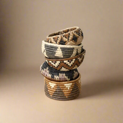 Stack of five South African woven baskets with geometric patterns in the woven basket set