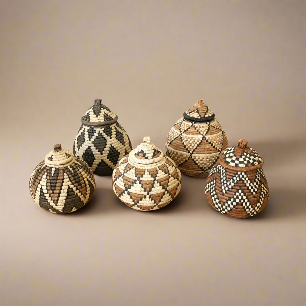 Colorful handmade woven baskets set from South Africa with lids and geometric patterns
