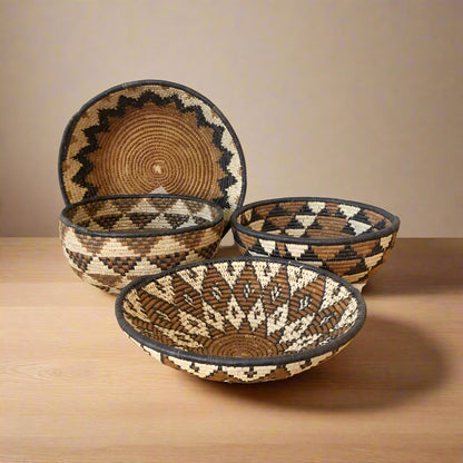 Four handmade eco-friendly woven bowls from South Africa with ilala palm and wild grasses