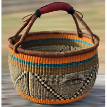 Handmade elephant grass market basket with leather handle and colorful striped design
