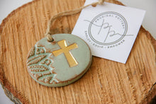 Gold leaf cross ornament in light green ceramic with textured pattern