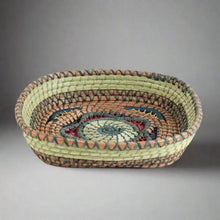 Handmade Guatemalan small basket with woven design, teal and red spiral pattern