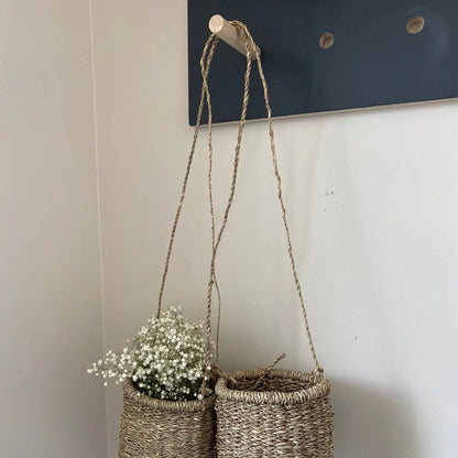 Handmade hanging seagrass basket with white flowers, perfect for your home decor
