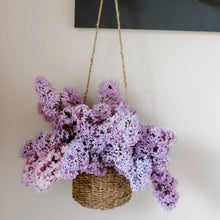 Hanging Seagrass Basket with Handmade Woven Design Overflowing with Purple Lilac Flowers