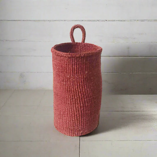 Handmade hanging sisal basket in red with a loop handle, perfect for home decor
