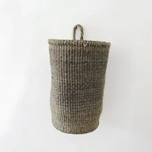 A handmade hanging sisal basket in olive green with a sturdy handle perfect as a hanging basket for storage