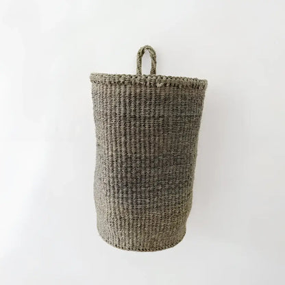 A handmade hanging sisal basket in olive green with a sturdy handle perfect as a hanging basket for storage