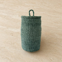 Handmade hanging sisal basket in teal with a sturdy woven pattern and looped handle for easy hanging