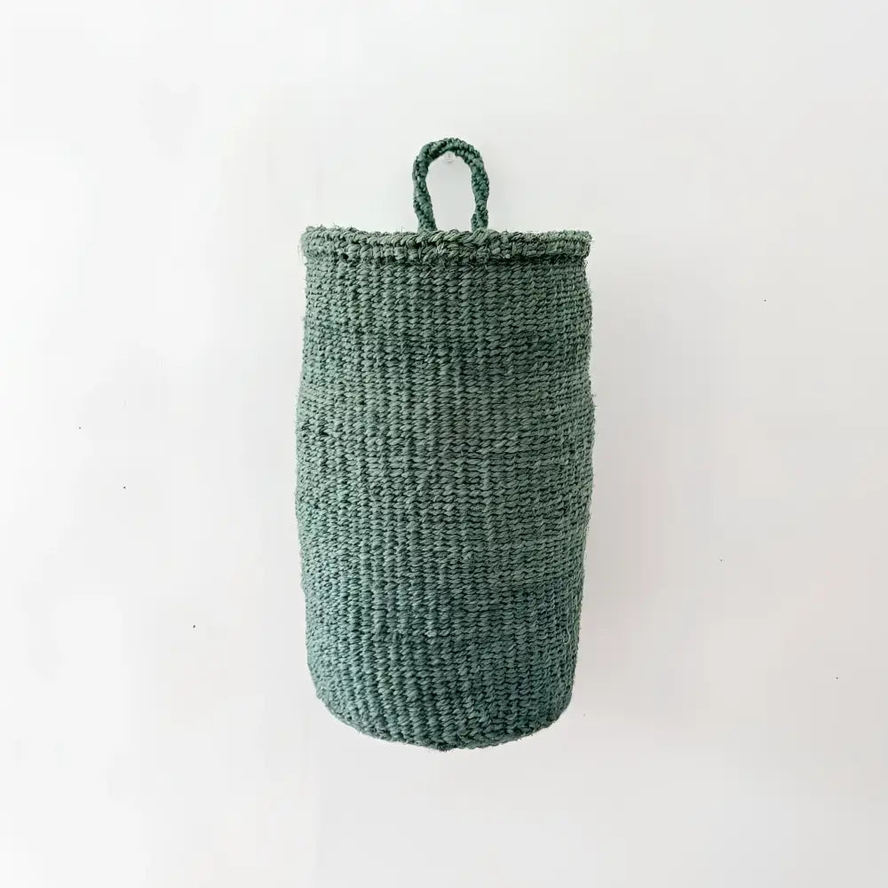 A dark green handmade hanging sisal basket with a looped handle for easy hanging and storage