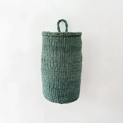 A dark green handmade hanging sisal basket with a looped handle for easy hanging and storage