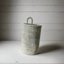 Handmade hanging sisal basket with gray and white stripes and a loop handle