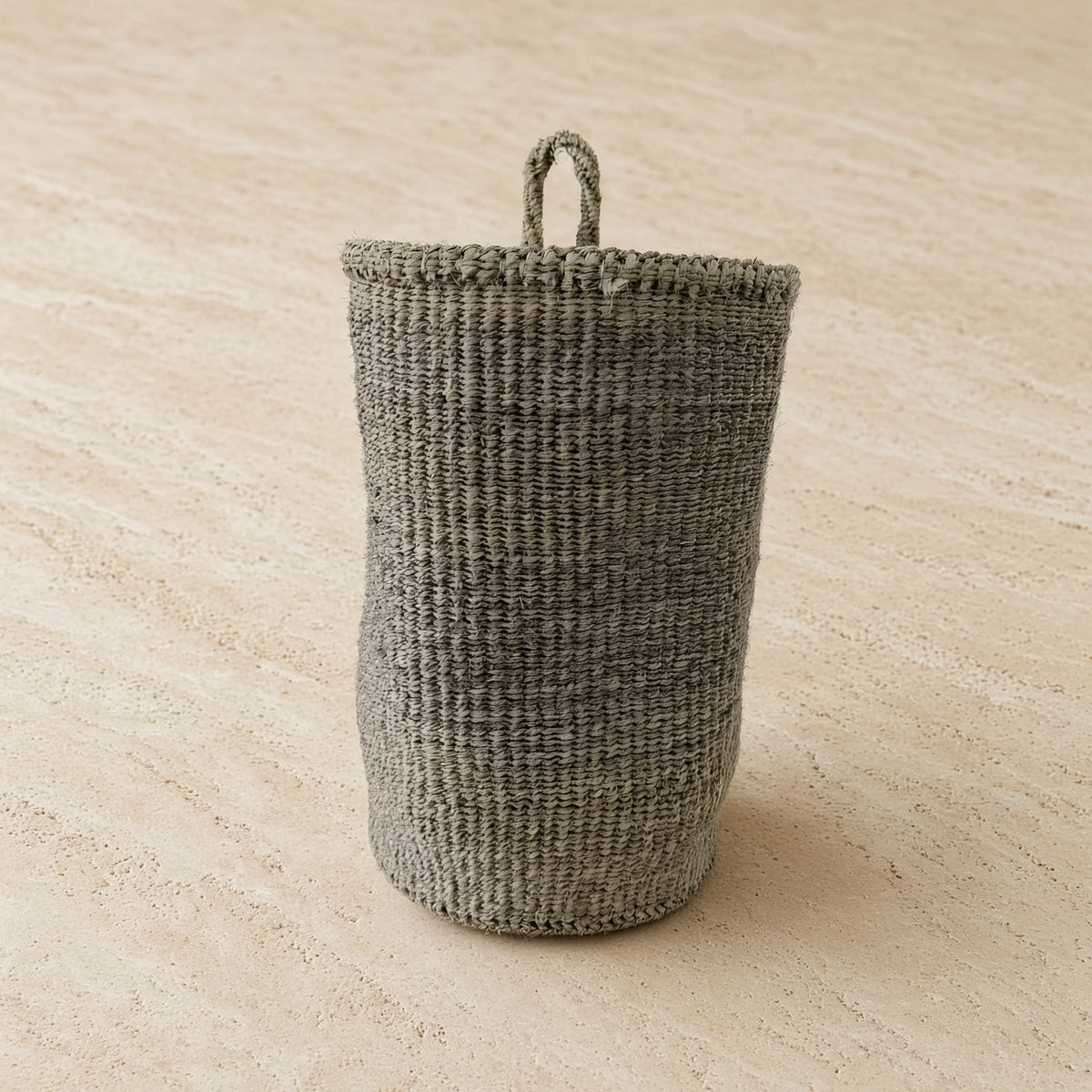 Gray handmade hanging sisal basket with looped handle perfect as a stylish hanging basket for decor