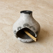 Handmade speckled gray ceramic birdhouse incense burner with black floral decals and open front for smudge sticks