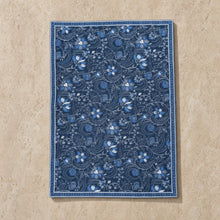 Handmade indigo blue cotton placemat with a floral paisley pattern and detailed border in lighter blue shades