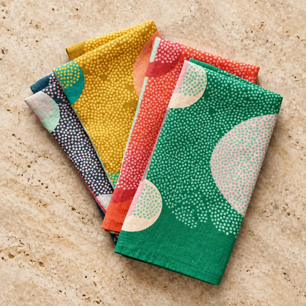 Set of 4 european linen napkins with bright modern designs in vivid yellow red green and navy with white dotted patterns