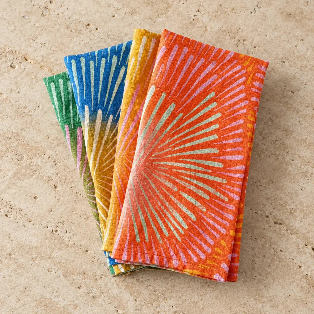 Handmade european linen napkins with bright colors set featuring bold radial burst patterns in orange yellow blue and green