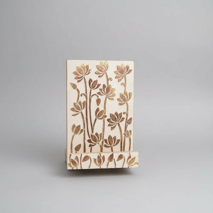 Hand-carved lotus mango wood tablet holder with floral rubber stamp on light wood