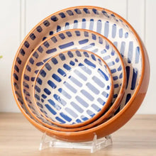 Three handmade nested Moroccan ceramic bowls with blue and white abstract dash pattern