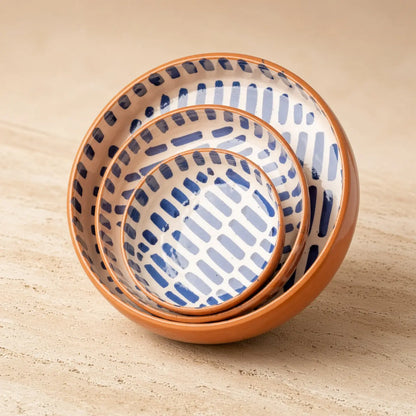 Set of three handmade moroccan ceramic nesting bowls with terracotta rims and blue and white geometric patterns