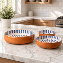Set of three handmade moroccan ceramic nesting bowls with blue and white terracotta and stripe patterns inside and rim