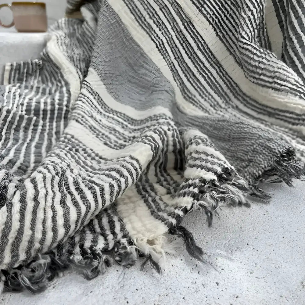 Soft handmade muslin cotton throw blanket with stripes and fringed edges in white and gray