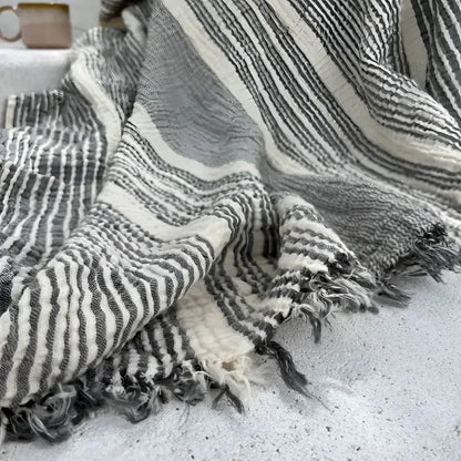 Soft handmade muslin cotton throw blanket with stripes and fringed edges in white and gray