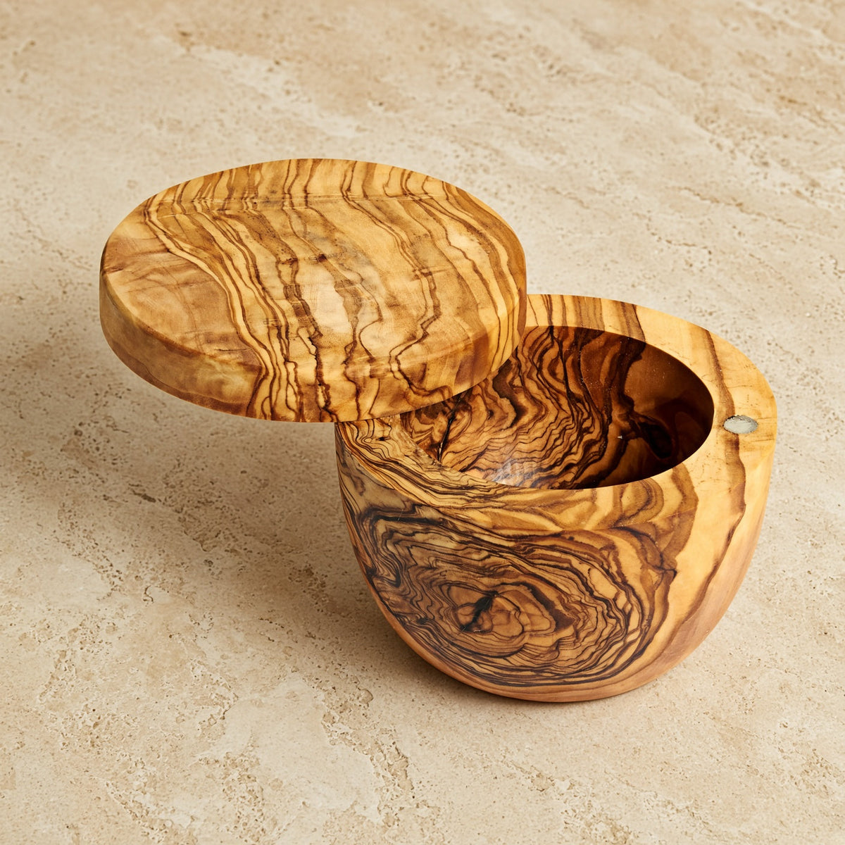 Handmade olive wood salt cellar with a smooth natural finish and a practical swivel lid for easy use